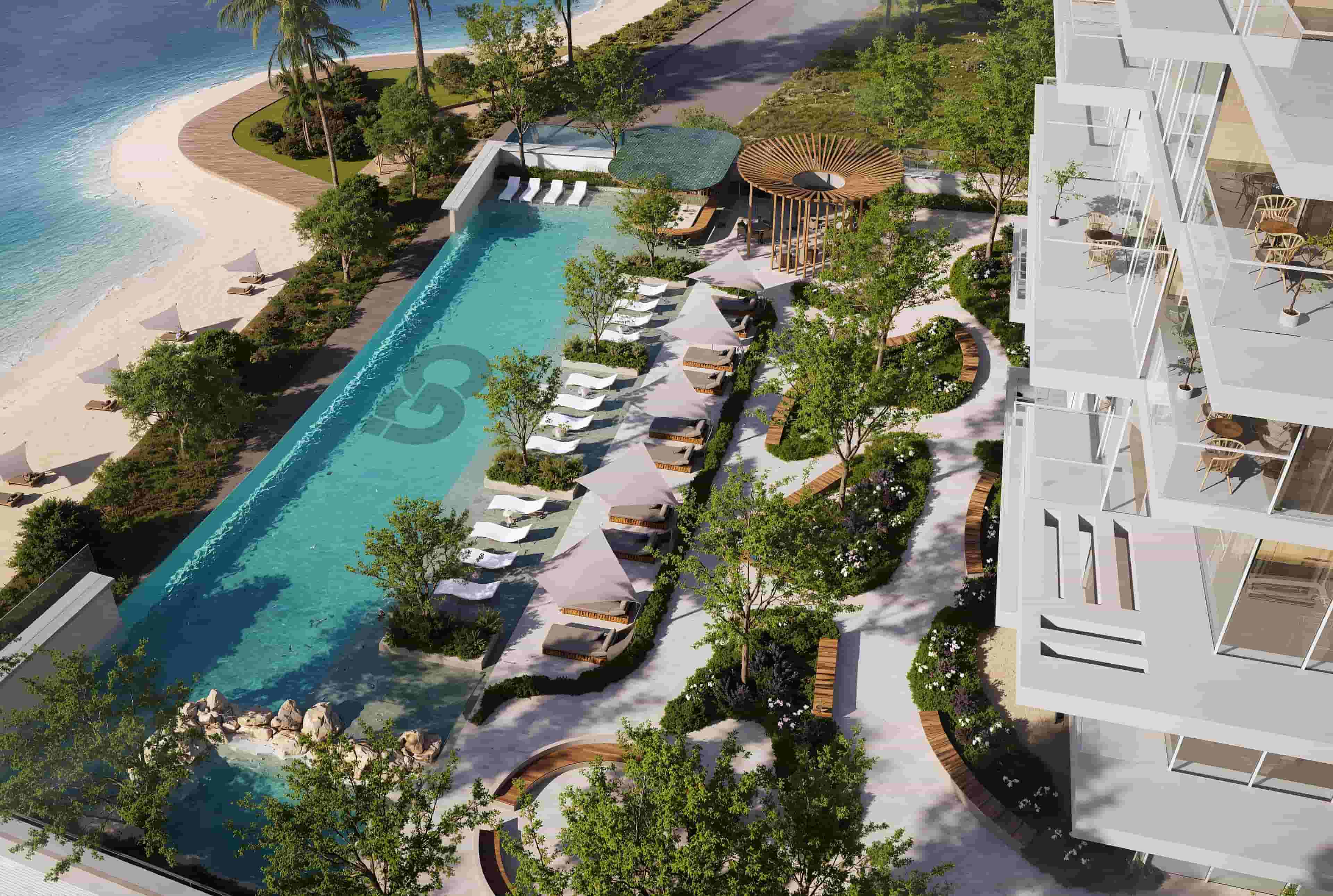 Luxury waterfront pool area with sun loungers, landscaped gardens, and modern residential balconies at Ayaan Heights in Meydan Horizon, Dubai.